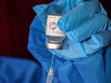 Corona Vaccine: वैज्ञानिकों की केंद्र से अपील, कोविड वैक्सीन की इमरजेंसी मंजूरी वापस लें