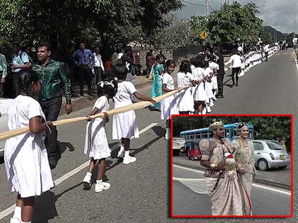 Couple Used 250 Students To Carry Longest Saree Under Investigation Now ৩.২ কিমি লম্বা শাড়ি বয়ে নিয়ে যেতে আড়াইশো পড়ুয়াকে নিয়োগ করল শ্রীলঙ্কার দম্পতি, শুরু তদন্ত