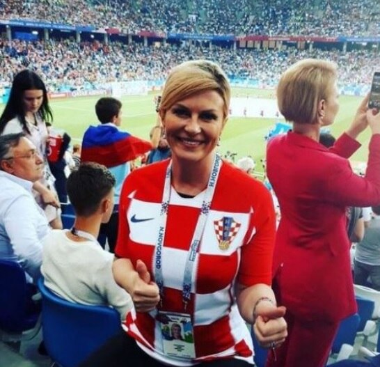 Croatia's president wins fans with show of VIP zone passion in front of Russin PM ভিডিওতে দেখুন, রাশিয়ার বিরুদ্ধে দল গোল করা ও জেতার পর ক্রোয়েশিয়ার প্রেসিডেন্টের নাচ