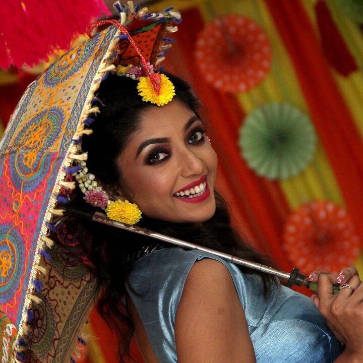 পরনে নীল রঙের গাউন। কানে, গলায় ফুলের মালা।