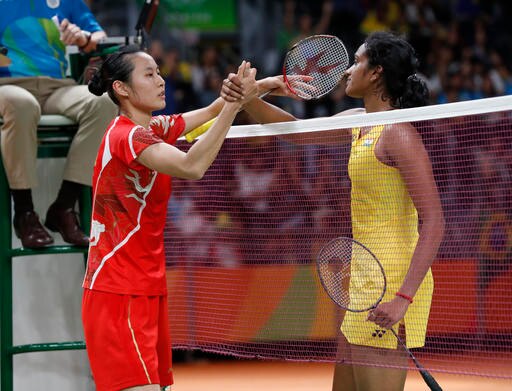 India's Sindhu Pusarla, right, greet by China's Wang Yihan after winning the Women's Singles Quarterfinal at the 2016 Summer Olympics in Rio de Janeiro, Brazil, Tuesday, Aug. 16, 2016. (AP Photo/Vincent Thian)