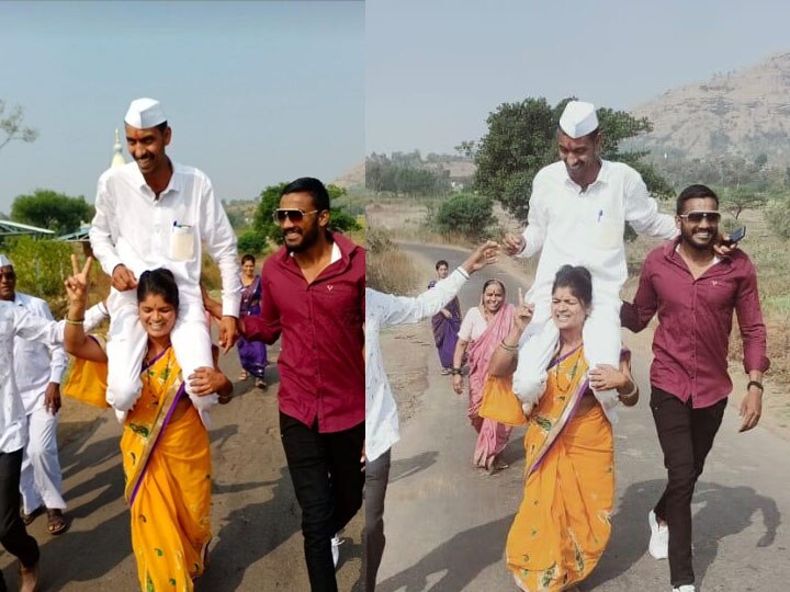 wife lift husband on her shoulders during his procession after winning Gram Panchayat Election 2021 Gram Panchayat Election Results 2021 | लय भारी! खांद्यावरून मिरवणूक काढत, पत्नीकडून पतीचा विजयोत्सव साजरा