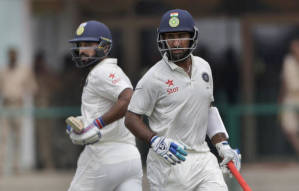 India's Murali Vijay, left and Cheteshwar Pujara, run between wickets against New Zealand during their first cricket test in Kanpur, India, Thursday, Sept. 22, 2016. (AP Photo/ Tsering Topgyal)