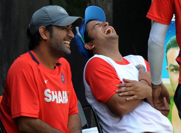 Indian cricketers Mahendra Singh Dhoni (L) and Suresh Raina laugh during a training session at The Punjab Cricket Associaton (PCA) Stadium in Mohali on March 29, 2011. India will face Pakistan in the second semi-final match of The ICC Cricket World Cup 2011 on March 30. AFP PHOTO/Indranil MUKHERJEE (Photo credit should read INDRANIL MUKHERJEE/AFP/Getty Images)
