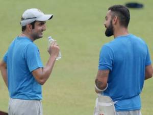 India's captain Virat Kohli (R) talks with teammate Gautam Gambhir during a training session in Kolkata on September 29, 2016 on the eve of the second cricket Test match between India and New Zealand at Eden Gardens. / AFP PHOTO / Dibyangshu SARKAR / ----IMAGE RESTRICTED TO EDITORIAL USE - STRICTLY NO COMMERCIAL USE----- / GETTYOUT