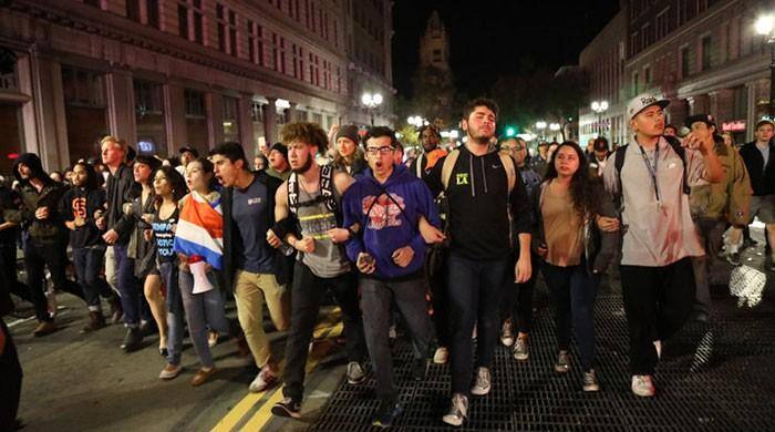 ਟਰੰਪ ਦੇ ਖਿਲਾਫ ਪ੍ਰਦਰਸ਼ਨ ਕਰਦੇ ਹੋਏ ਅਮਰੀਕੀ।