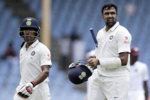 India's middle order batsmen Ravichandran Ashwin, right, and Wriddhiman Saha walk of the field at lunch during day two of their third cricket Test match at the Daren Sammy Cricket Ground in Gros Islet, St. Lucia, Wednesday, Aug. 10, 2016. (AP Photo/Ricardo Mazalan)