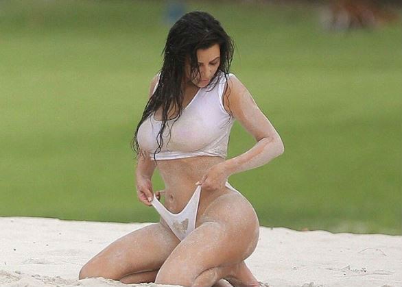 SEE PICS: Kim Kardashian flashes underb**b & her famous BUTT in a WHITE HOT SWIMSUIT!