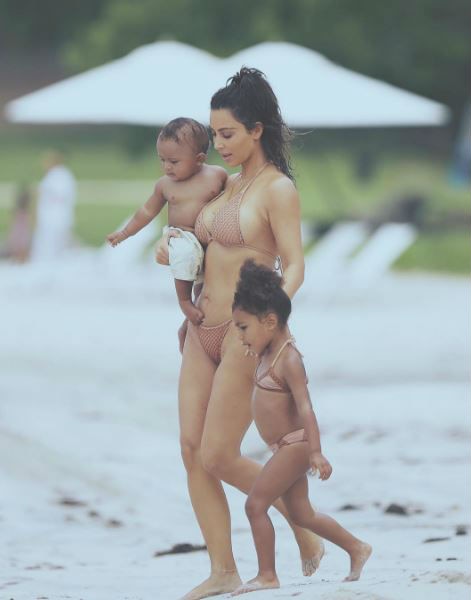 SEE PICS: Kim Kardashian flashes underb**b & her famous BUTT in a WHITE HOT SWIMSUIT!
